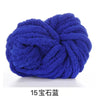 A ball of deep blue chunky chenille yarn used for knitting and crochet
