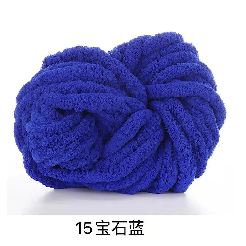 A ball of deep blue chunky chenille yarn used for knitting and crochet