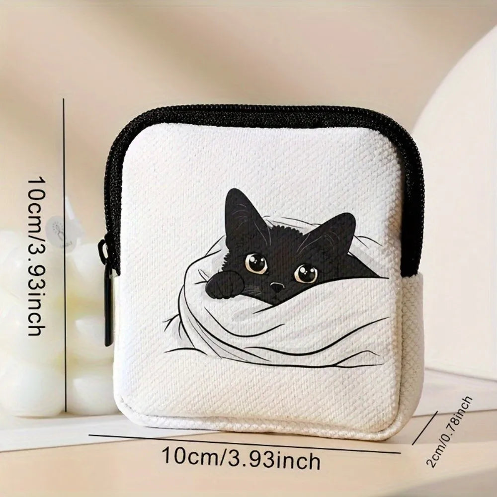A white mini coin purse featuring a black cat sleeping inside a white fabric lining.