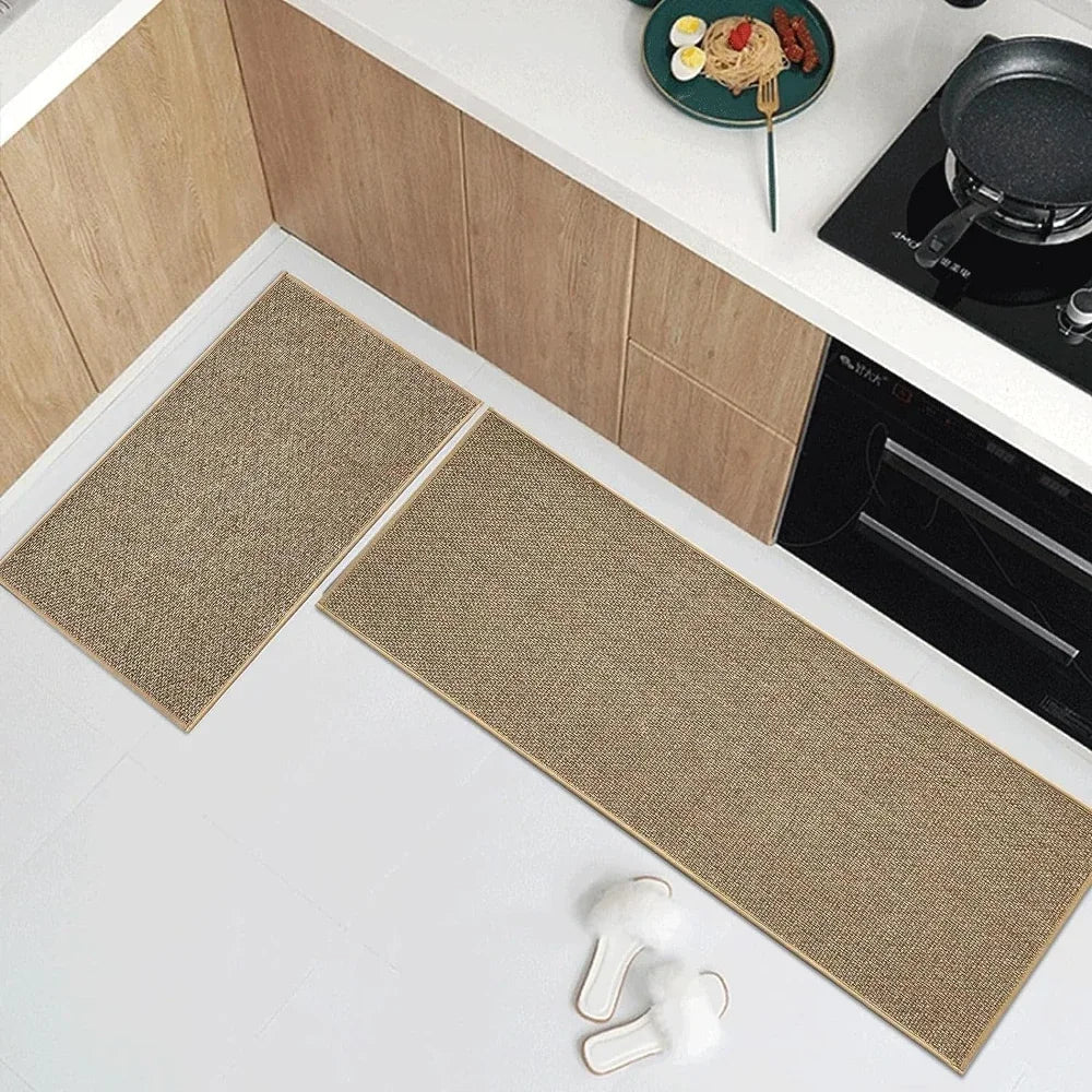A rectangular beige washable non-slip kitchen runner rug placed on a white countertop next to a stovetop.