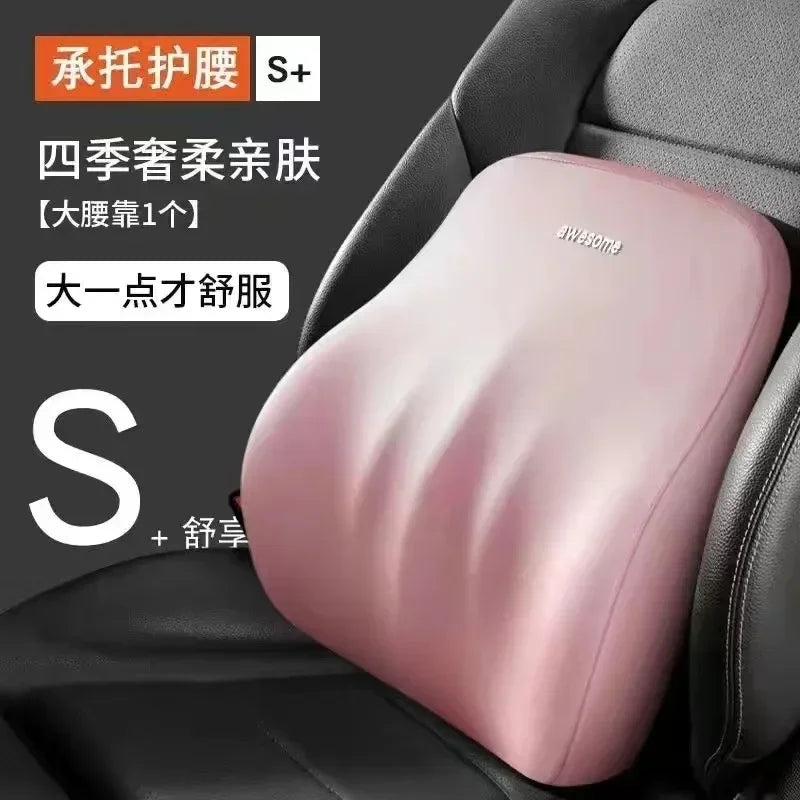 Pink memory foam car headrest and lumbar support pillow placed on a black car seat.