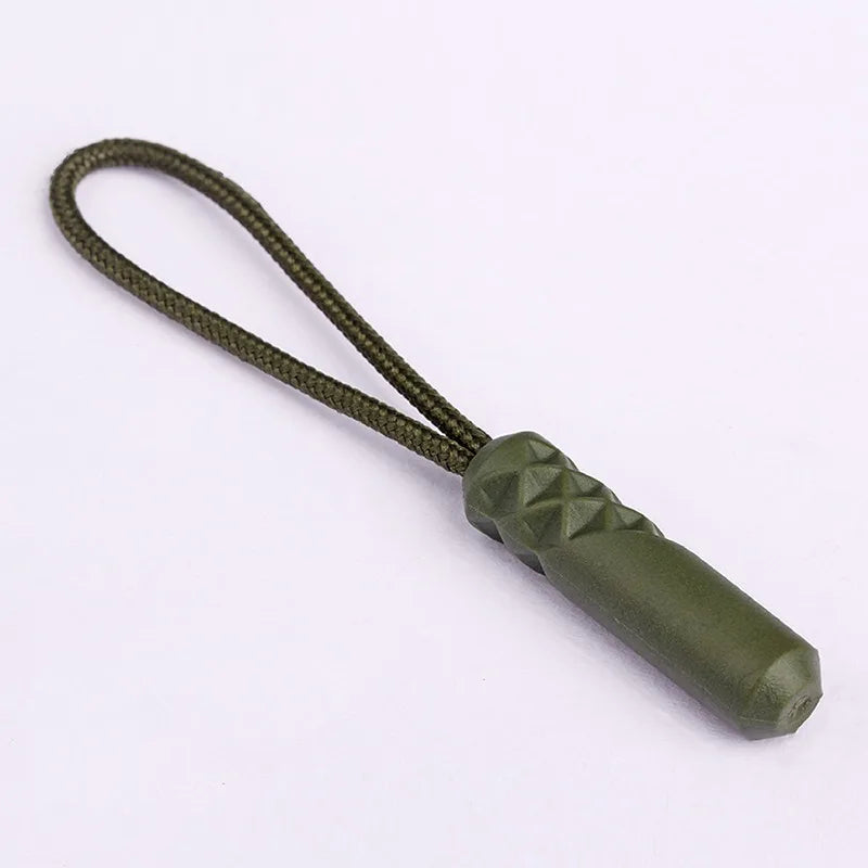 A replacement zipper pull with a nylon cord and a green, textured metal-like cap.