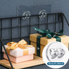 A set of no-drill adhesive hooks is displayed on a shelf with wrapped gifts and a black metal rack.