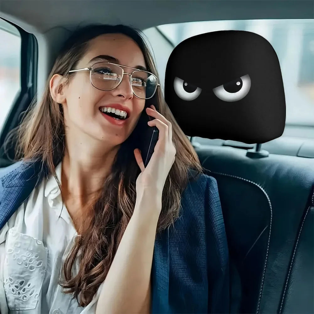 A woman is using a phone while sitting in a car, with a black headrest cover visible.