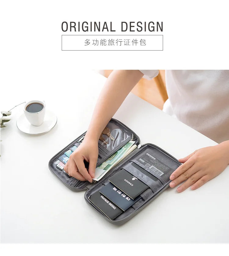 A hand is opening a dark gray waterproof document organizer wallet filled with various passports and documents on a white tab