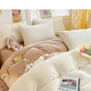 A cozy milk velvet bedding set featuring a duvet cover and pillowcases displayed on a bed.