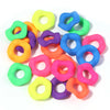 A collection of colorful acrylic spacer beads shaped like waves in various shades of green, yellow, purple, and blue.