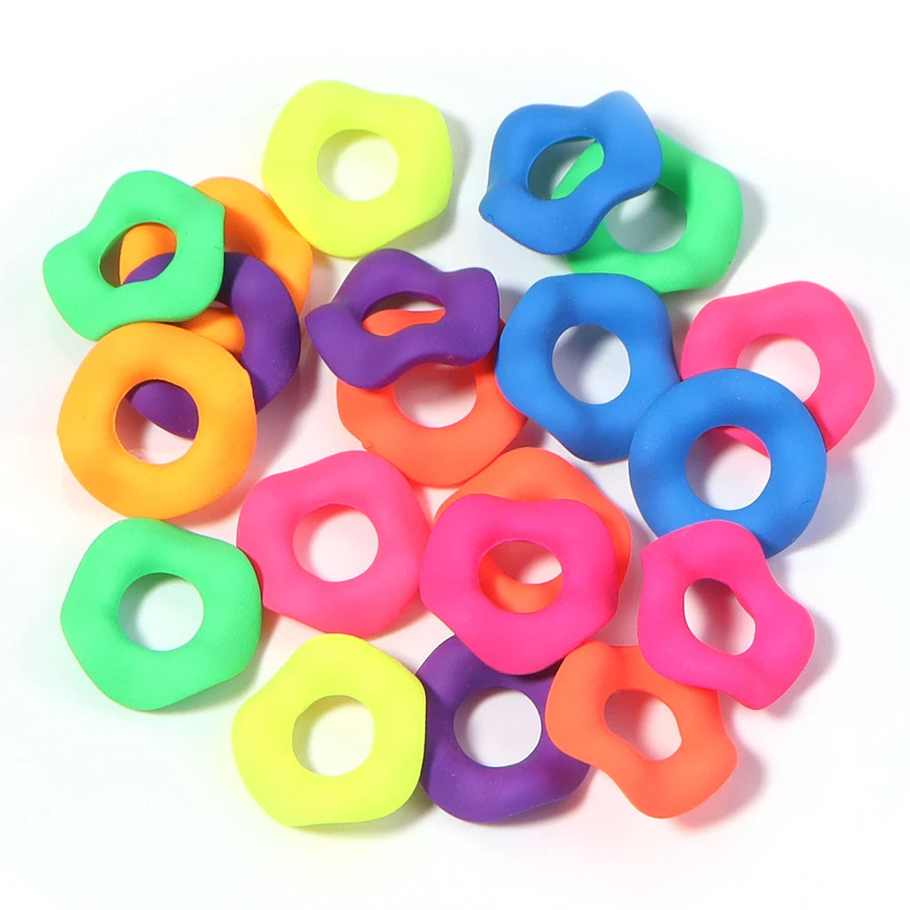 A collection of colorful acrylic spacer beads shaped like waves in various shades of green, yellow, purple, and blue.