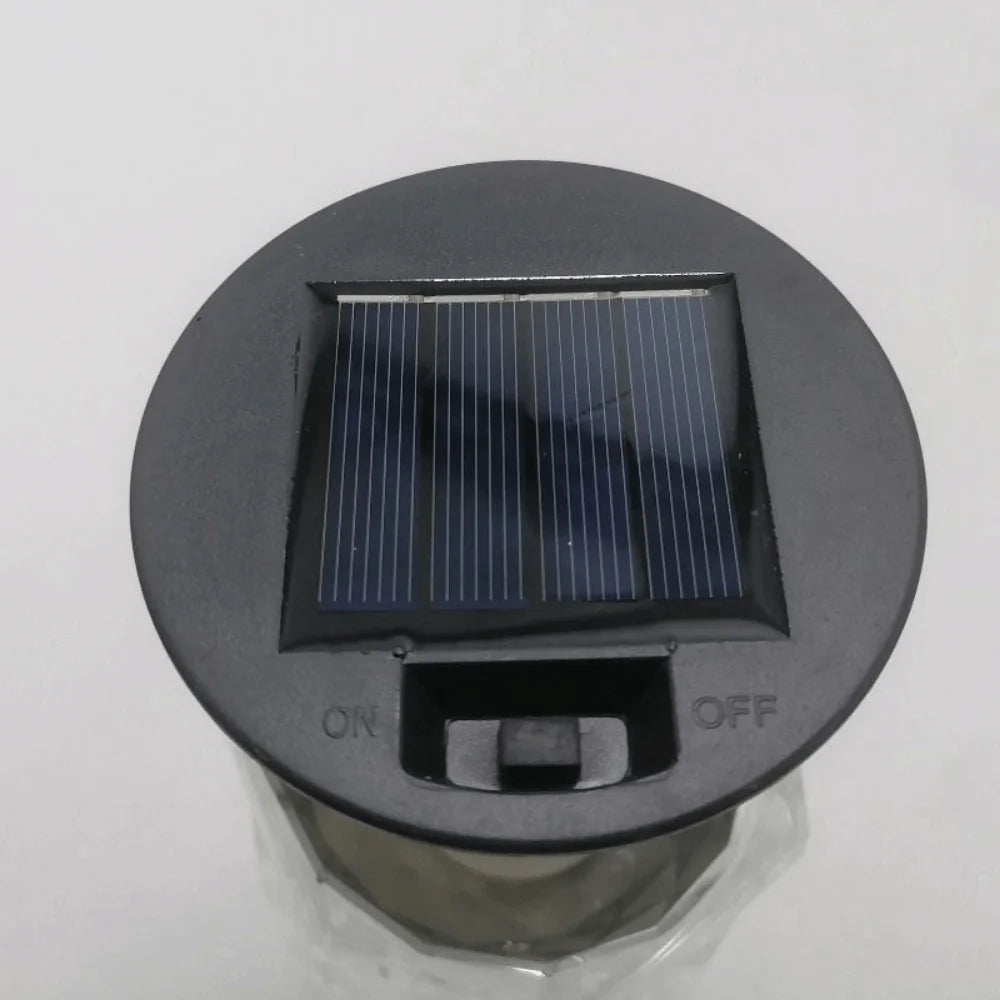 A round, dark gray lantern top with a rectangular solar panel and ON/OFF switches.