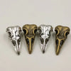 A set of five gothic skull and crow head charms for jewelry making, featuring silver and bronze finishes.