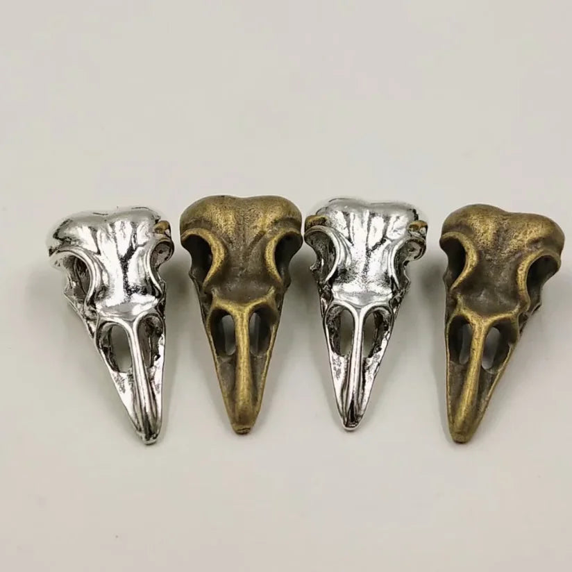 A set of five gothic skull and crow head charms for jewelry making, featuring silver and bronze finishes.