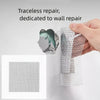 A hand applies a translucent, mesh drywall repair patch to a wall surface.