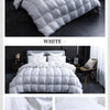 A white quilted goose down duvet with a cotton cover displayed on a bed.
