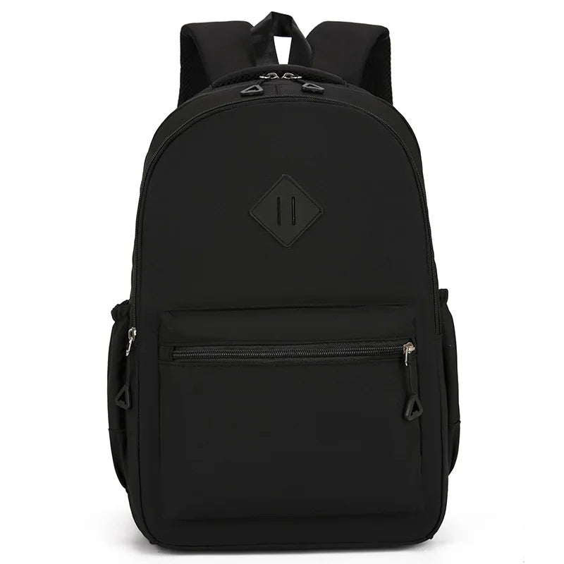 A black urban nylon backpack with a main compartment and a zippered pocket.