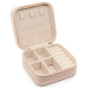 A light beige PU leather jewelry storage box with a hinged lid and divided compartments.