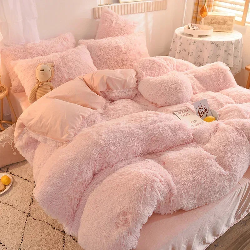 A pink plush mink velvet duvet cover set with sheets displayed on a bed.