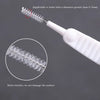 A white shower cleaning brush with nylon bristles is shown, demonstrating its use for cleaning holes greater than 0.7mm.