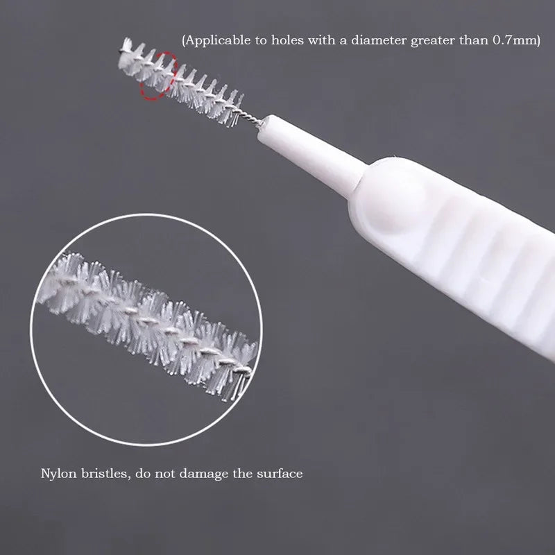 A white shower cleaning brush with nylon bristles is shown, demonstrating its use for cleaning holes greater than 0.7mm.