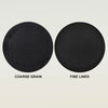 Two black exfoliating body scrub gloves showing coarse grain and fine lines textures.