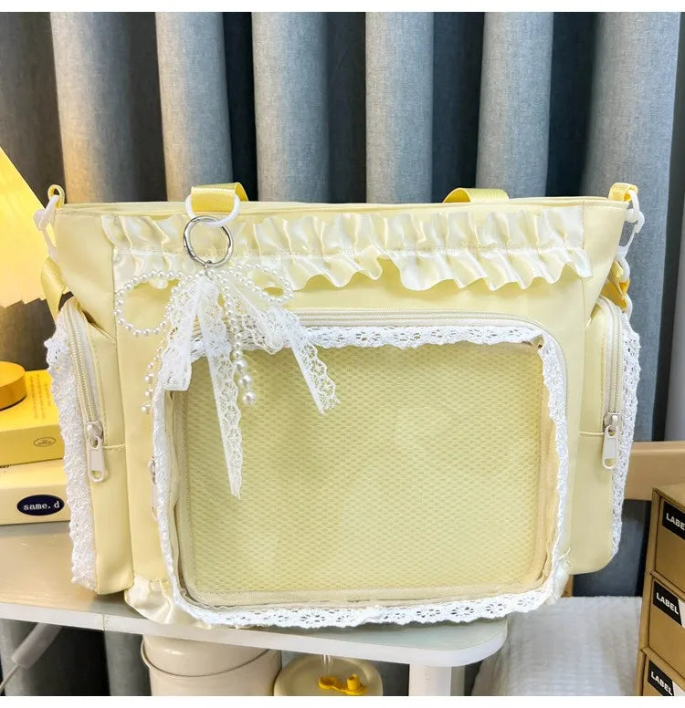 A pale yellow transparent shoulder bag with white lace trim and a decorative bow detail.