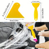 A hand is using a yellow squeegee tool to apply window tint film to a car window.
