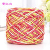 A ball of pink and yellow metallic silk crochet yarn used for knitting and macrame