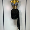 A mannequin displays a sparkly two-piece party outfit featuring a sheer top and a black draped skirt.