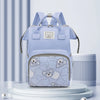 A light blue bear print waterproof diaper backpack displayed on a white stand.