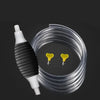A white manual siphon pump is shown next to a coiled clear tube, demonstrating fluid transfer.
