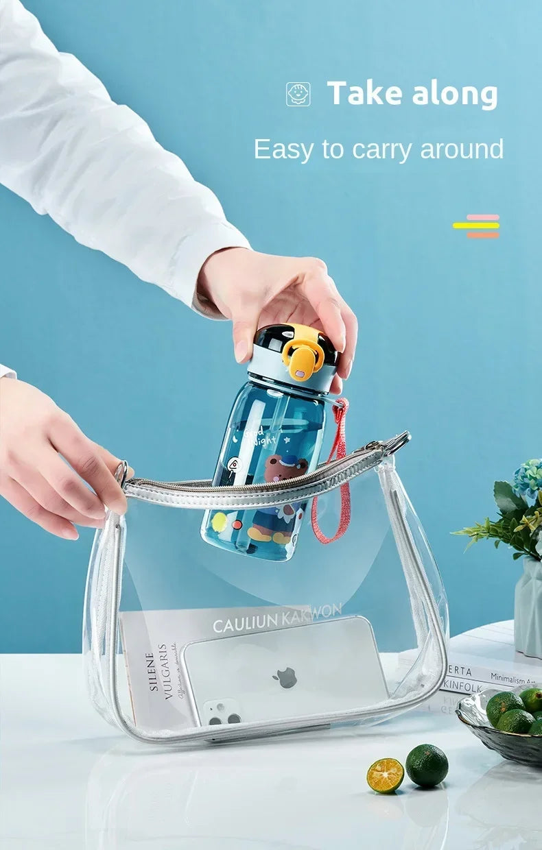 A clear silicone case holds a blue cartoon straw water bottle with a leakproof lid.