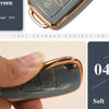 A hand holds a soft, light green TPU silicone car key case with a gold finish.