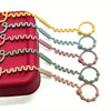 A set of silicone anti-drop pacifier clips and teethers in various pastel colors, including yellow, green, pink, and beige.