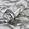 Roll of waterproof self-adhesive marble wallpaper featuring gray and white veining on a marbled surface.