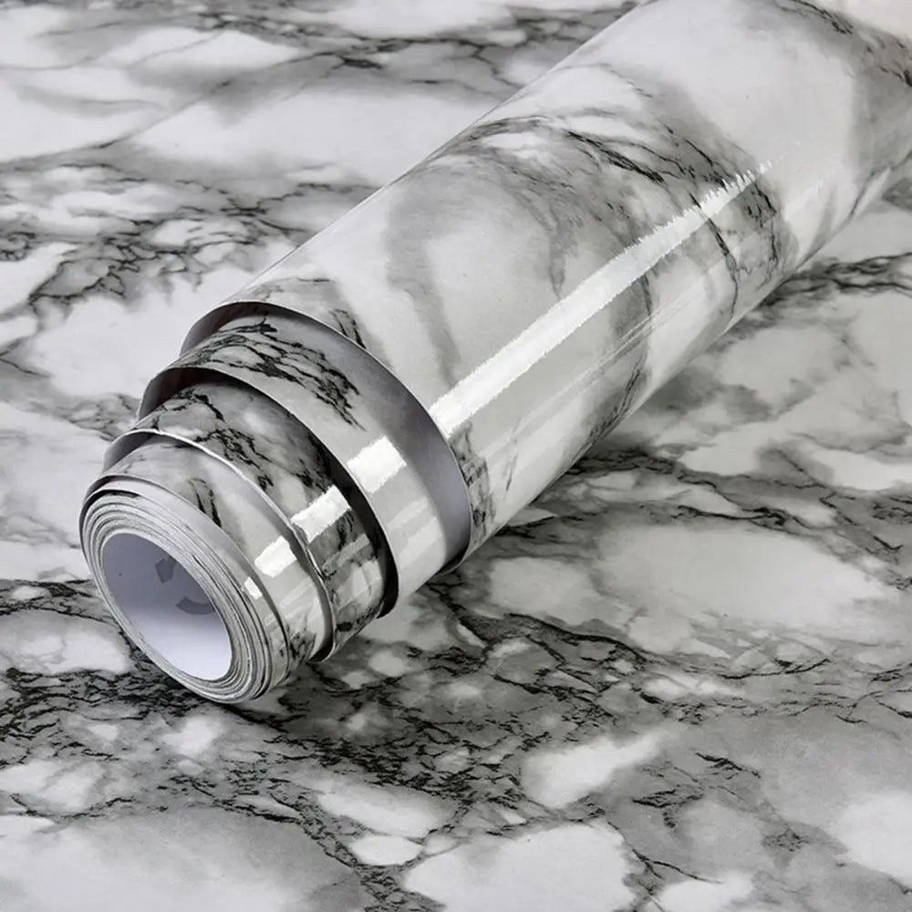 Roll of waterproof self-adhesive marble wallpaper featuring gray and white veining on a marbled surface.