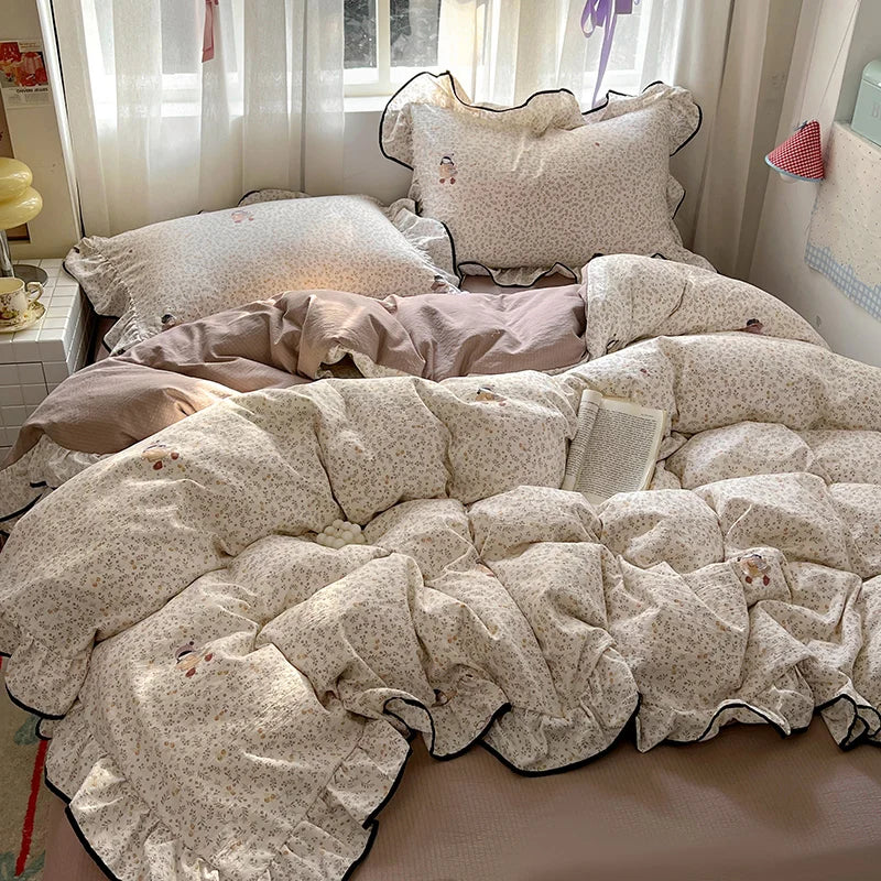 A floral duvet cover set with pillowcases and a flat sheet displayed on a bed.