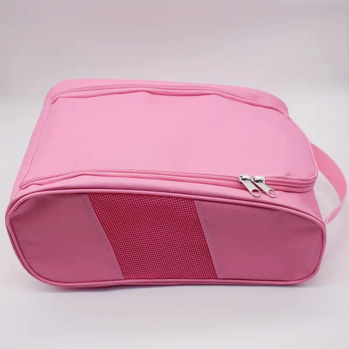 A pink breathable oxford cloth shoe storage bag shown from the top view.