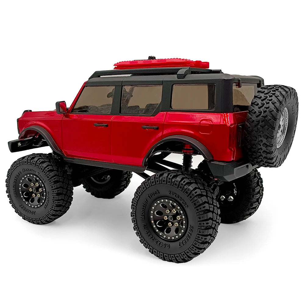 Red RC truck with black body and tires, featuring rubber mud terrain tires.