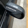 A black rain guard visor is shown attached to a Jeep Compass side mirror.