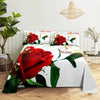 A white bedding set featuring a large red rose print with green leaves and a woven pendant light above it.