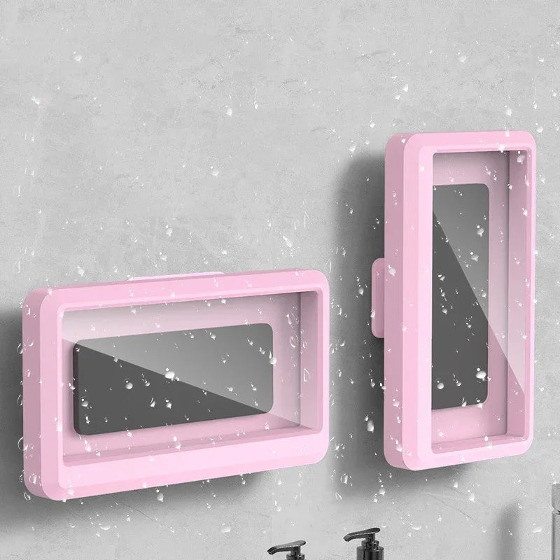 Pink universal waterproof shower phone case with anti-fog screen mounted on a gray wall.