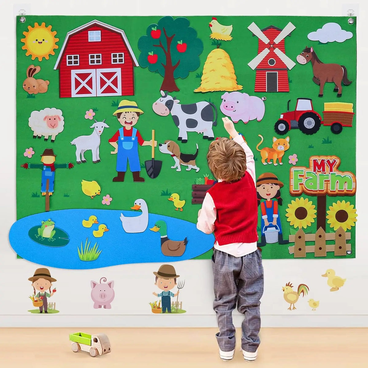 A large felt storytelling board featuring various farm and zoo animals like a pig, cow, sheep, dog, and various fruits and ve