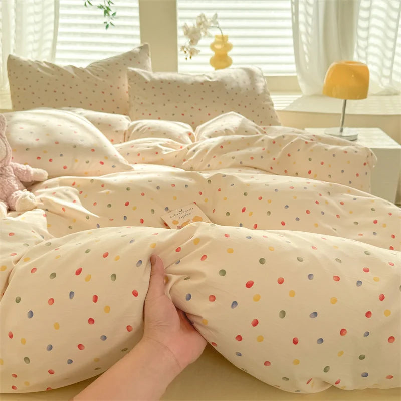 A beige duvet cover set with a cute dog print pattern and matching pillowcases is displayed on a bed.