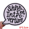 A black and white embroidered iron-on patch shaped like a speech bubble with the text Shhh I'm Introverting