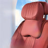 A close-up of a pink memory foam car lumbar support and neck pillow set.