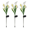 Three white calla lily LED garden lights with long metal stakes and black bases