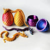 A set of three articulated dragon figurines resembling pineapples, featuring glowing or textured skin in orange and yellow to