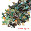 A collection of green agate tumbled crystal stone chips in various shades and sizes.