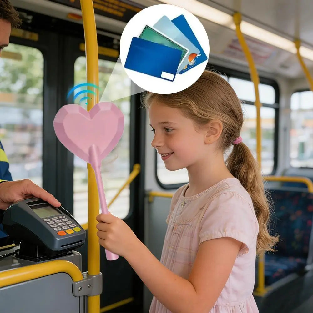 A young girl is using a star-shaped contactless card payment wand on a public transit fare reader.