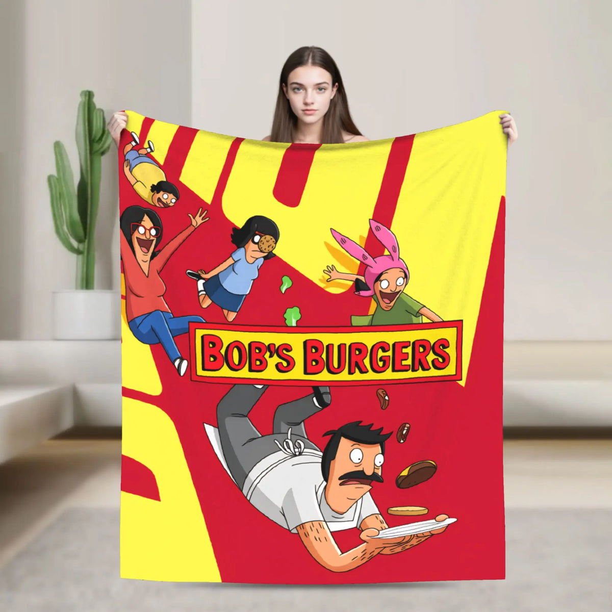 A colorful cartoon illustration featuring characters in a vibrant yellow and red design on a throw blanket.