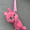 A pink, fluffy plush toy resembling a rabbit character hanging by a pink strap.